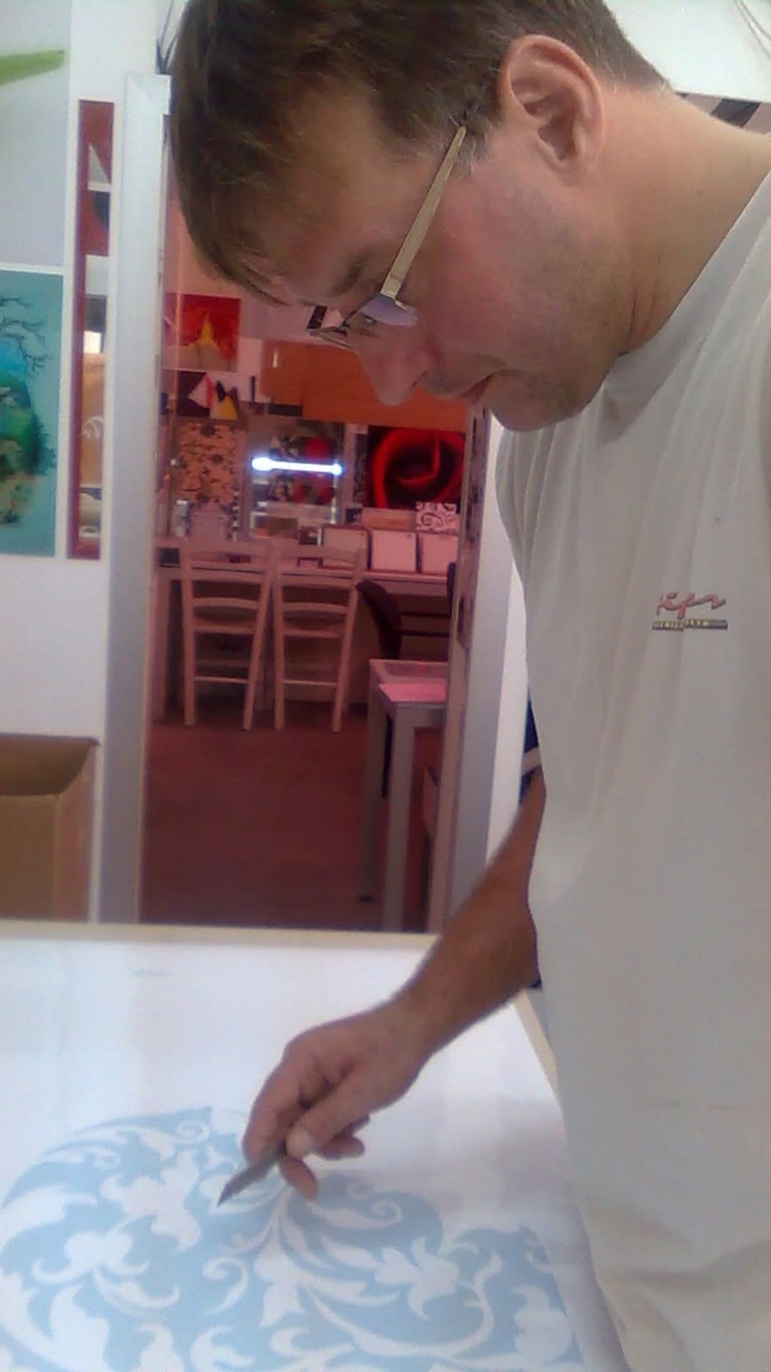 The artist working on a decorative surface